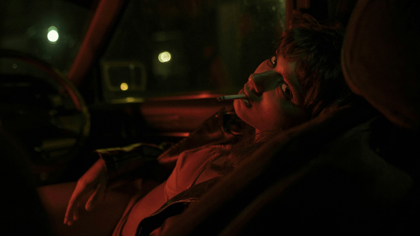 Person sitting in a car at night, used for a THC driving safety article.